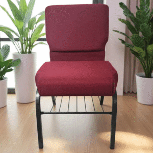 A red cushioned chair with a black metal frame between two potted plants.