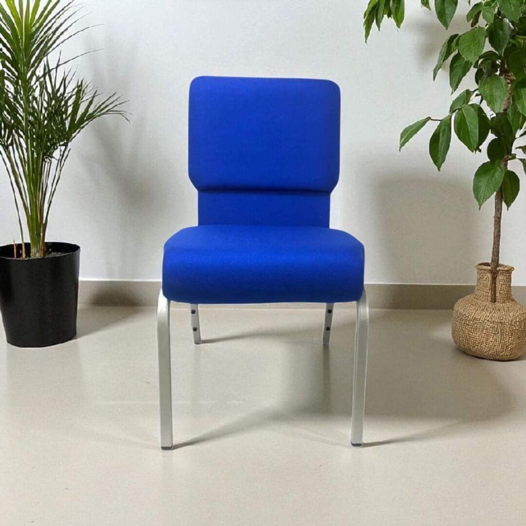 Blue upholstered chair with metal legs in a minimalist room.