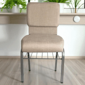 A beige cushioned chair with metal legs in a bright room.