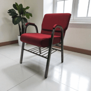 Red cushioned chair with metal frame in a bright room.
