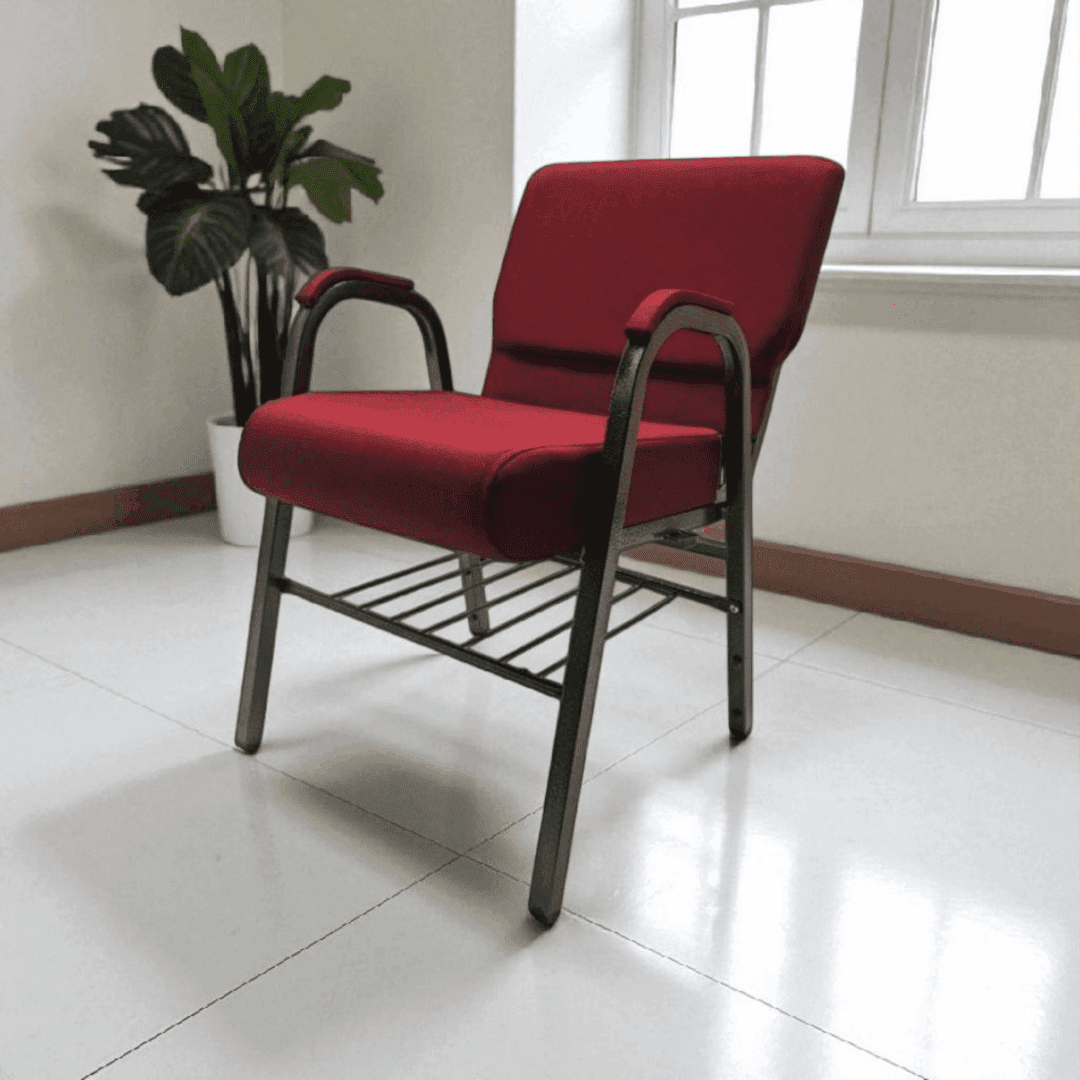Red cushioned chair with metal frame in a bright room.